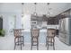 Kitchen island with seating, stainless steel appliances, and modern cabinetry at 2490 Southlawn Ln, Clermont, FL 34714