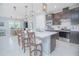 Modern kitchen boasts a large island with seating, stainless steel appliances, and ample counter space at 2490 Southlawn Ln, Clermont, FL 34714