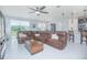 Spacious living room features a large sectional sofa, stylish ceiling fan, and plenty of natural light at 2490 Southlawn Ln, Clermont, FL 34714