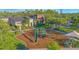 Playground area with modern equipment and nearby buildings at 2490 Southlawn Ln, Clermont, FL 34714