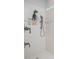Shower featuring multiple shower heads and a built-in shelving niche for soaps and shampoo at 2490 Southlawn Ln, Clermont, FL 34714