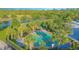 Aerial view of a splash pad with tables, umbrellas and palm trees at 2490 Southlawn Ln, Clermont, FL 34714
