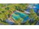 Aerial view of a splash pad with tables, umbrellas and palm trees at 2490 Southlawn Ln, Clermont, FL 34714