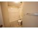 Bright bathroom featuring a tub with tile surround and a white toilet at 2586 Robert Trent Jones Dr # 1116, Orlando, FL 32835