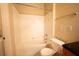 Bright bathroom featuring a tub with tile surround and a white toilet at 2586 Robert Trent Jones Dr # 1116, Orlando, FL 32835