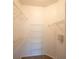 Walk-in closet featuring carpeted floor and wire shelving at 2586 Robert Trent Jones Dr # 1116, Orlando, FL 32835