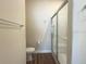 Bathroom featuring a glass-enclosed shower with wood-look vinyl floors at 2611 Shantiniketan Blvd # G-11, Tavares, FL 32778