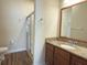 Bathroom with granite counters and a glass-enclosed shower at 2611 Shantiniketan Blvd # G-11, Tavares, FL 32778