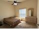 Bedroom with large window for natural light and carpet flooring at 2611 Shantiniketan Blvd # G-11, Tavares, FL 32778