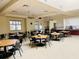 Spacious dining area with many tables and chairs perfect for community gatherings or events at 2611 Shantiniketan Blvd # G-11, Tavares, FL 32778