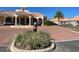Beautiful view of the entrance to a community with a gated entry and a circular driveway at 2611 Shantiniketan Blvd # G-11, Tavares, FL 32778