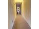 Neutral-toned hallway with tiled floors leading to the other rooms at 2611 Shantiniketan Blvd # G-11, Tavares, FL 32778