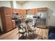 Open-concept kitchen featuring stainless steel appliances and an eat-in dining area at 2611 Shantiniketan Blvd # G-11, Tavares, FL 32778