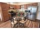 Open-concept kitchen featuring stainless steel appliances and an eat-in dining area at 2611 Shantiniketan Blvd # G-11, Tavares, FL 32778
