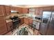 Open-concept kitchen featuring stainless steel appliances and granite countertops at 2611 Shantiniketan Blvd # G-11, Tavares, FL 32778