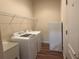 A convenient laundry room with a modern washer and dryer set and overhead shelving at 2611 Shantiniketan Blvd # G-11, Tavares, FL 32778
