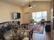 Open-concept living room featuring hardwood floors and a large picture window at 2611 Shantiniketan Blvd # G-11, Tavares, FL 32778