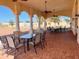 Inviting covered patio features a dining area with ceiling fans, offering a perfect spot for outdoor meals and relaxation at 2611 Shantiniketan Blvd # G-11, Tavares, FL 32778