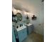 Bright bathroom featuring dual sinks, stylish lighting, and a neutral color palette with tile accent wall at 2667 River Landing Dr, Sanford, FL 32771