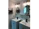 Bathroom has dual sinks with updated fixtures, with an oval mirror, and hexagon tile accent wall at 2667 River Landing Dr, Sanford, FL 32771