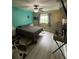 Well-lit bedroom has a ceiling fan, large windows, and minimalist decor, offering comfortable living space at 2667 River Landing Dr, Sanford, FL 32771