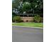 Stone community sign reading 'Riverview', beautifully landscaped with palm trees and lush greenery at 2667 River Landing Dr, Sanford, FL 32771