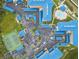Aerial view showcasing the community with blue roofs, tennis courts, pool, parking, and landscaped grounds at 2700 N Peninsula Ave # 314, New Smyrna Beach, FL 32169