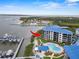 Aerial view of a condominium complex with a pool overlooking a serene marina at 2700 N Peninsula Ave # 314, New Smyrna Beach, FL 32169