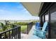 Exterior balcony featuring furniture, railings, and lush greenery with a beautiful water view at 2700 N Peninsula Ave # 314, New Smyrna Beach, FL 32169