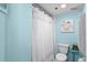 Cozy bathroom with a white shower curtain, toilet, and refreshing blue walls provides a clean and inviting space at 2700 N Peninsula Ave # 314, New Smyrna Beach, FL 32169