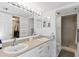 Well-lit bathroom with double sinks, neutral color scheme, and glass-enclosed shower at 2700 N Peninsula Ave # 314, New Smyrna Beach, FL 32169