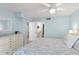 Bright bedroom with ensuite bathroom, light blue walls, and dresser at 2700 N Peninsula Ave # 314, New Smyrna Beach, FL 32169