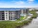 Exterior shot of condo building with pool and bay access, highlighting the beautiful waterfront location at 2700 N Peninsula Ave # 314, New Smyrna Beach, FL 32169