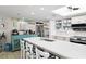 Open kitchen with stainless appliances, stone countertops, island with seating and decor at 2700 N Peninsula Ave # 314, New Smyrna Beach, FL 32169
