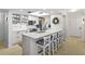 Bright kitchen featuring an island with seating and white cabinetry, offering a modern and inviting space at 2700 N Peninsula Ave # 314, New Smyrna Beach, FL 32169