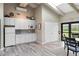 Community kitchenette featuring white cabinets, a microwave, refrigerator, and easy access to the outside at 2700 N Peninsula Ave # 314, New Smyrna Beach, FL 32169