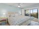 Serene main bedroom with balcony access, ceiling fan, and soft, calming colors at 2700 N Peninsula Ave # 314, New Smyrna Beach, FL 32169
