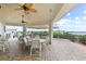 Outdoor seating area featuring tables and chairs with ceiling fans overhead and views of the waterfront and docks at 2700 N Peninsula Ave # 314, New Smyrna Beach, FL 32169