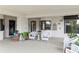 Inviting patio area with white wicker furniture and lush potted plants create a relaxing outdoor space at 2700 N Peninsula Ave # 314, New Smyrna Beach, FL 32169