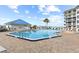 Beautiful pool area with comfortable lounge chairs overlooking the water and lush landscaping, perfect for relaxation at 2700 N Peninsula Ave # 314, New Smyrna Beach, FL 32169