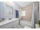 Bathroom with a tub/shower combination, updated vanity, and neutral color scheme at 2707 Prince John Rd, Winter Park, FL 32792
