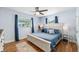 Cozy bedroom with a ceiling fan, comfortable bed with blue comforter and stylish decor at 2707 Prince John Rd, Winter Park, FL 32792