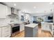 Modern kitchen featuring white cabinets, stainless steel appliances, and a kitchen island at 2707 Prince John Rd, Winter Park, FL 32792