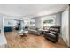 Bright living room featuring light wood floors, comfortable seating, and ample natural light at 2707 Prince John Rd, Winter Park, FL 32792