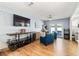 Stylish living room featuring hardwood floors, a wine rack, and an entertainment center at 2707 Prince John Rd, Winter Park, FL 32792