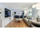 Open living room boasts wood flooring, comfortable seating, and a built-in entertainment center at 2707 Prince John Rd, Winter Park, FL 32792