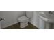 Bathroom featuring a pedestal sink and modern toilet at 2976 Embark Trail, St Cloud, FL 34771