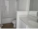 Modern bathroom with white cabinets, dual sinks, and bathtub with shower at 2976 Embark Trail, St Cloud, FL 34771