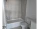 Bathroom featuring tiled walls, toilet, and bathtub at 2976 Embark Trail, St Cloud, FL 34771