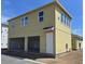 Bright yellow two-story home with a two-car garage and a white front door at 2976 Embark Trail, St Cloud, FL 34771